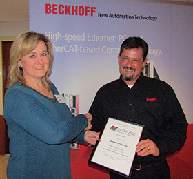 Ann de Beer (left) presents Kenneth McPherson with the SAIMC certificate.